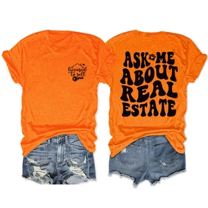 Flat lay of an orange cotton t-shirt and denim shorts with real estate agent slogans