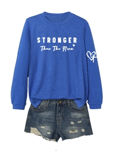 Detail of royal blue crewneck sweatshirt with STRONGER text and distressed denim shorts