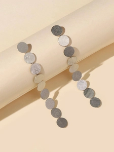 Detail of long drop earrings with eleven circular brushed silver metal discs