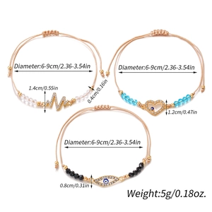 Three minimalist hand-woven string bracelets with gold-tone crystal charms and adjustable cord
