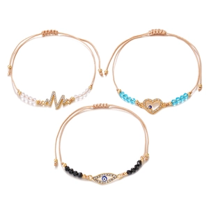 Three-piece gold-plated braided rope bracelet set with evil eye and heart charms