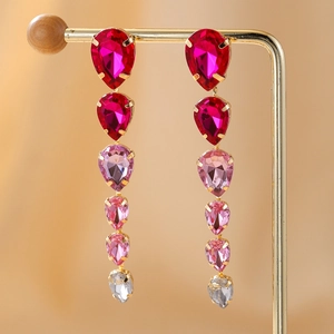 Detailed view of long gradient teardrop rhinestone tassel earrings in gold plating
