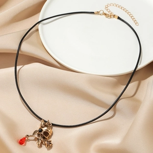 Gothic leather choker featuring antique gold skull with rose and red crystal drop