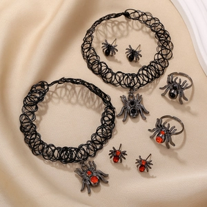 Gothic spider jewelry set including chokers, earrings, and rings with red gems