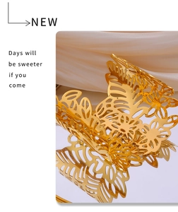 Detailed macro view of 18k gold plated hollow leaf pattern on a stainless steel bangle