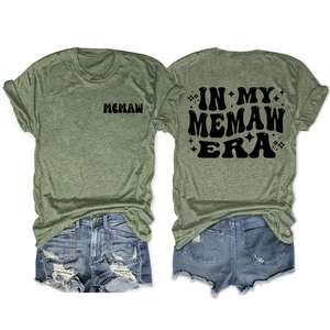 Flat lay detail of olive green Memaw Era T-shirt and distressed denim shorts set