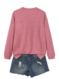Detailed flat lay of pink long sleeve top and distressed denim shorts with frayed hems