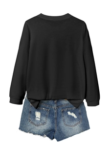 Back view of black long-sleeved sweatshirt paired with distressed blue denim shorts