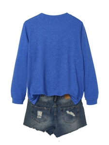 Back view of navy long-sleeve top and distressed denim shorts with frayed hems