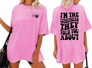 Pink oversized T-shirt featuring Esthetician back print and front bone hand icon