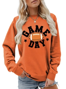Detail of orange crewneck sweatshirt featuring Game Day lettering and football graphic print