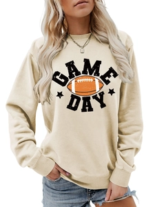 Close-up of ribbed cuffs and Game Day football print on beige crewneck sweatshirt