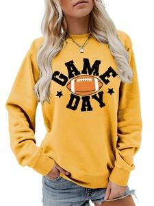 Close-up of vibrant yellow sweatshirt with Game Day football graphic and ribbed cuffs