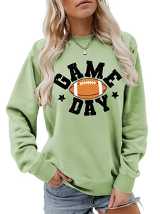 Close-up of mint green Game Day sweatshirt featuring retro football print and stars
