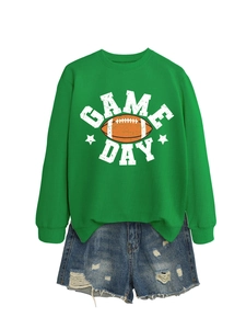 Flat lay of green Game Day sweatshirt and distressed denim shorts with fringe details