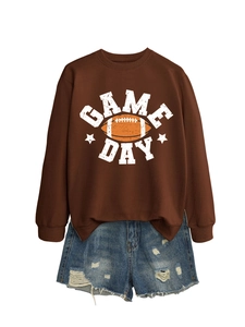 Brown long-sleeved sweatshirt with GAME DAY print and ripped denim shorts ensemble