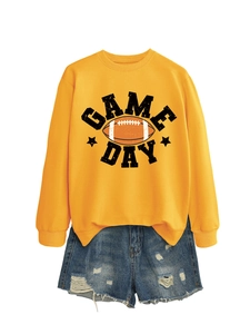 Flat lay of yellow Game Day crewneck sweatshirt with vintage football print and denim shorts