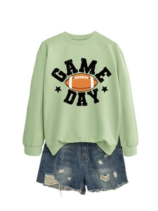 Close-up of Game Day graphic on mint green crewneck sweatshirt with denim shorts