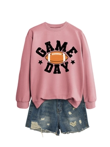 Detail view of pink sweatshirt with Game Day football print and distressed denim shorts