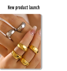 Detail of 18k gold and silver geometric lava rings with irregular texture on hand