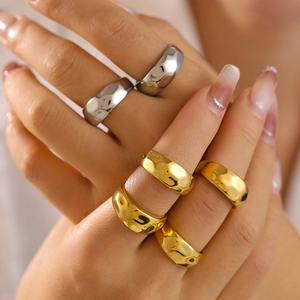 Irregular geometric textured wide rings in gold and silver finish on hands