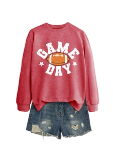 Flat lay of red Game Day crewneck sweatshirt paired with distressed denim shorts