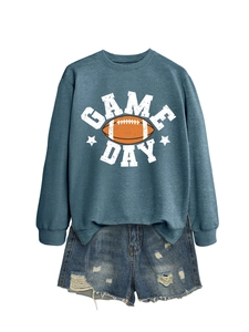 Flat lay detail of blue Game Day sweatshirt with distressed denim shorts on white background