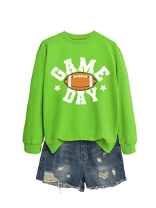 Detail view of Game Day text and football print on neon green sweatshirt with denim shorts