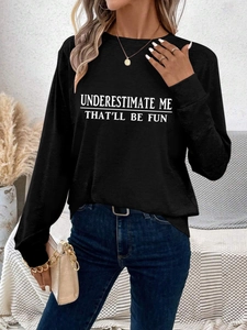 Detail of female model wearing black slogan sweatshirt with Underestimate Me print