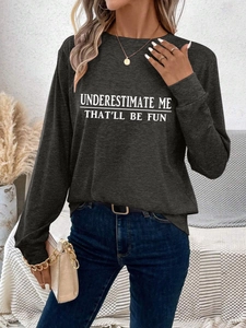 Close-up of white slogan print on a dark grey long sleeve t-shirt fabric texture