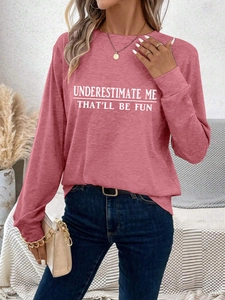 Detail of dusty rose sweatshirt with white Underestimate Me That'll Be Fun lettering