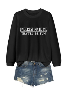 Detail of black long sleeve sweatshirt with white slogan print and ripped denim shorts