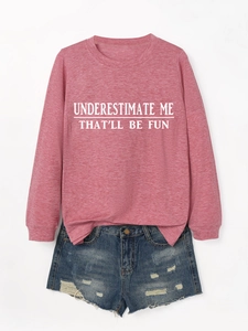 Detail of pink long sleeve sweatshirt with white slogan and distressed denim shorts