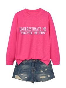 Flat lay of pink sweatshirt with quote print and distressed denim shorts on white background