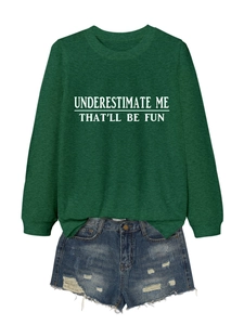 Flat lay of green crewneck sweatshirt with slogan and distressed denim shorts