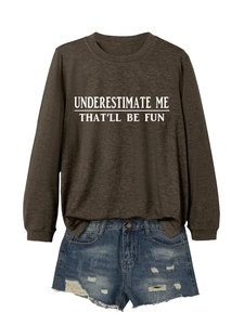 Flat lay of brown long sleeve sweatshirt with white slogan print and ripped denim shorts