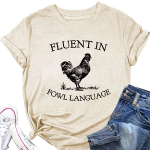 Flat lay of beige T-shirt with rooster print and Fluent in Fowl Language slogan