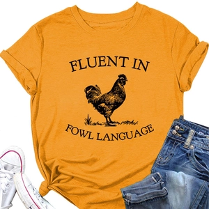 Detail view of yellow cotton t-shirt with rooster print and fowl language slogan text