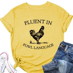 Detail of yellow cotton t-shirt featuring rooster print and rolled cuff sleeve design