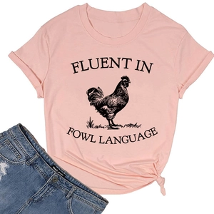 Flat lay of pink cotton T-shirt with rooster graphic and denim shorts casual outfit