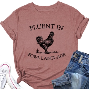 Detail of humor text print and rooster graphic on dusty rose cotton T-shirt