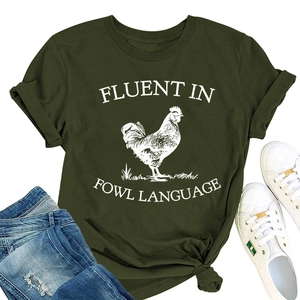 Flat lay of dark green T-shirt with rooster print and denim jeans on white background
