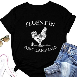 Flat lay of black 'Fluent in Fowl Language' rooster t-shirt with jeans and sneakers