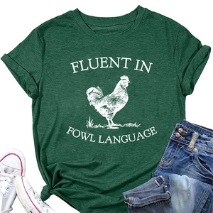 Detail of green T-shirt with white rooster print and Fluent in Fowl Language text