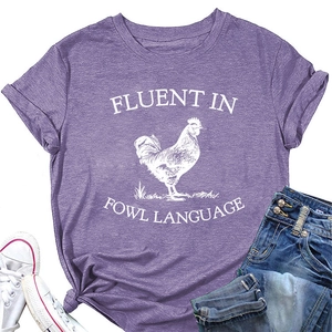 Detail of purple cotton T-shirt featuring white rooster print and fluent in fowl language text