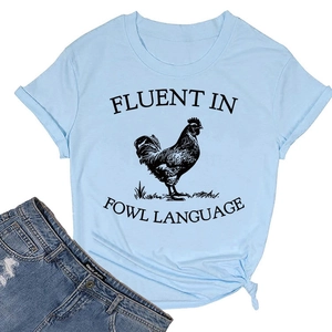 Detail of light blue knot-hem t-shirt with rooster print and humorous slogan