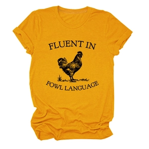 Close-up of rooster graphic and Fluent in Fowl Language text on a yellow cotton t-shirt