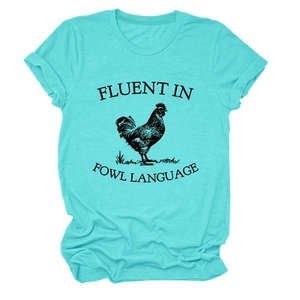 Detail of teal cotton T-shirt featuring a black rooster and Fluent In Fowl Language text