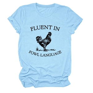 Detail of light blue cotton T-shirt featuring a rooster print and fluent in fowl language text