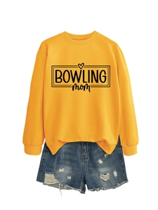 Flat lay of yellow bowling mom sweatshirt with distressed denim shorts on white background